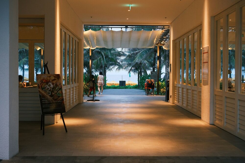 A breezy, palm-lined resort walkway, the kind of guest experience Grackle's back-office systems keep running smoothly