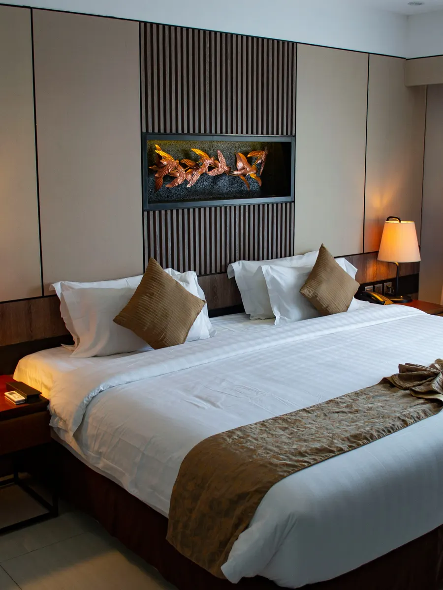 Hotel room with turned-down king bed